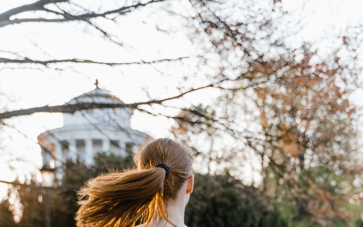 Woman jogging in a park as part of a healthy weight loss lifestyle